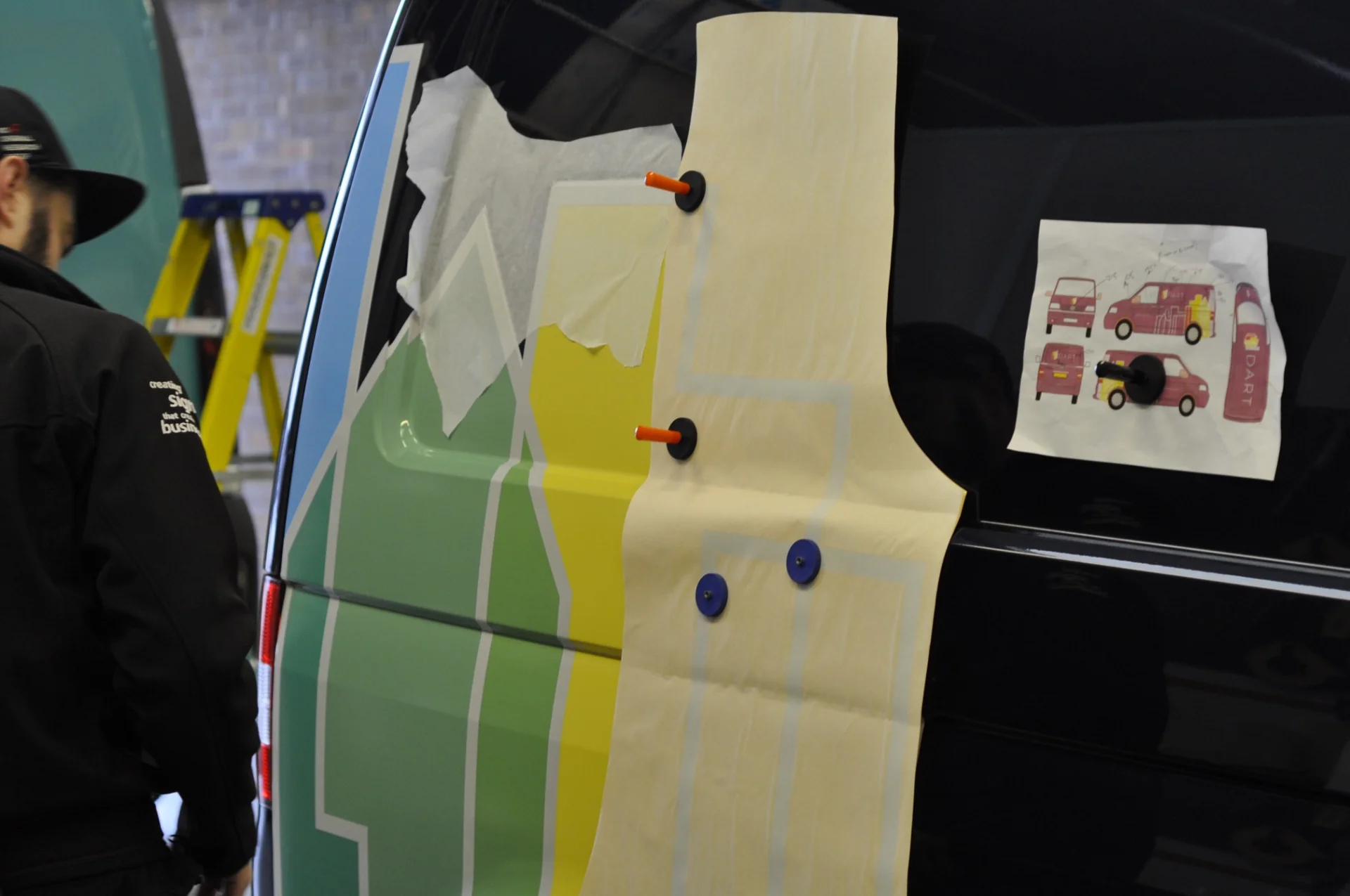 DART van livery being fitted, with the printed vehicle design alongside the coloured vinyl graphics