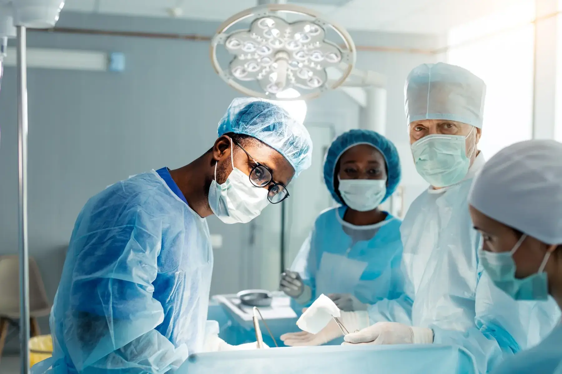 Surgical team wearing protective clothing in an operating theatre