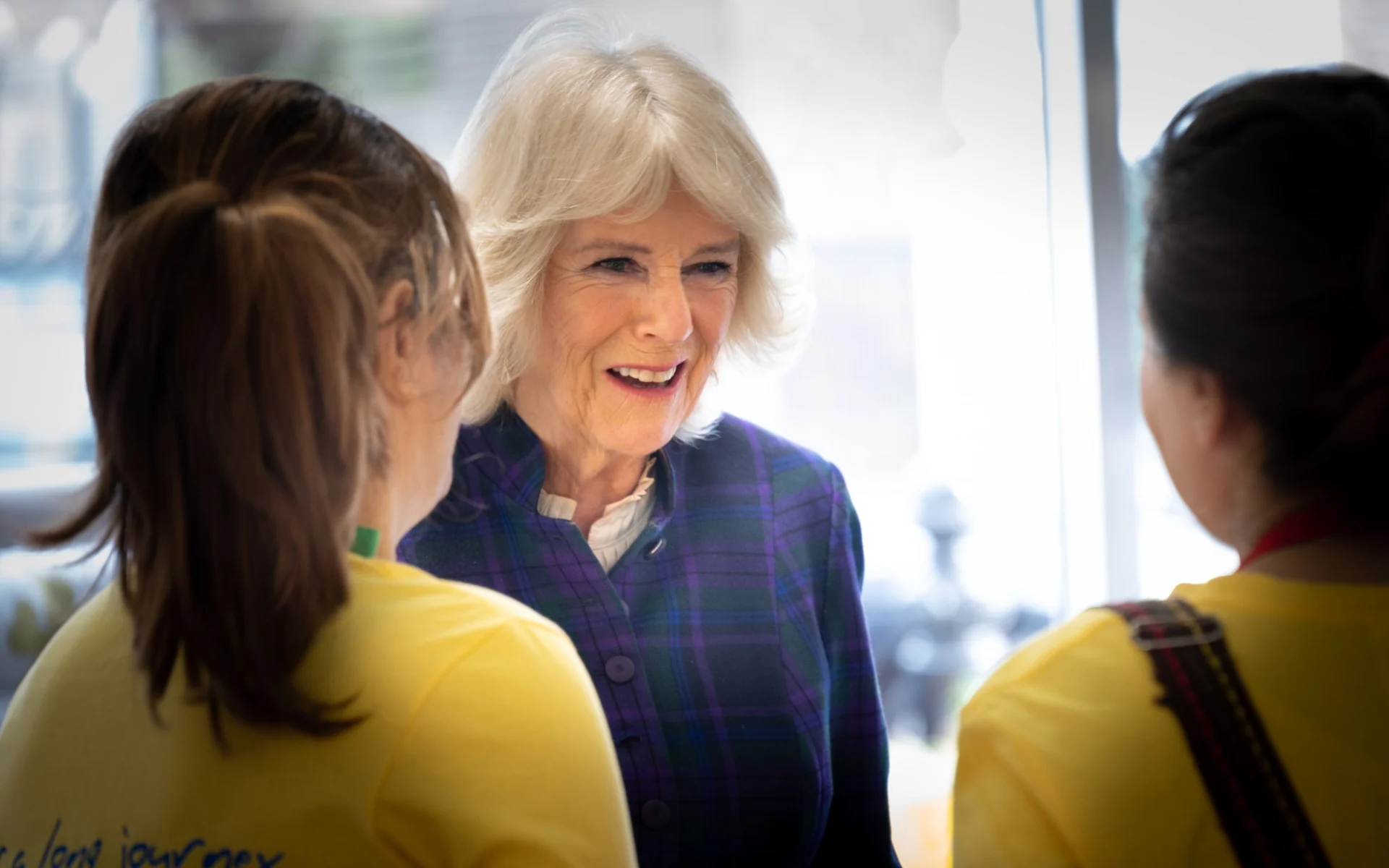 The Queen meeting UK Harvest team members wearing yellow charity shirts