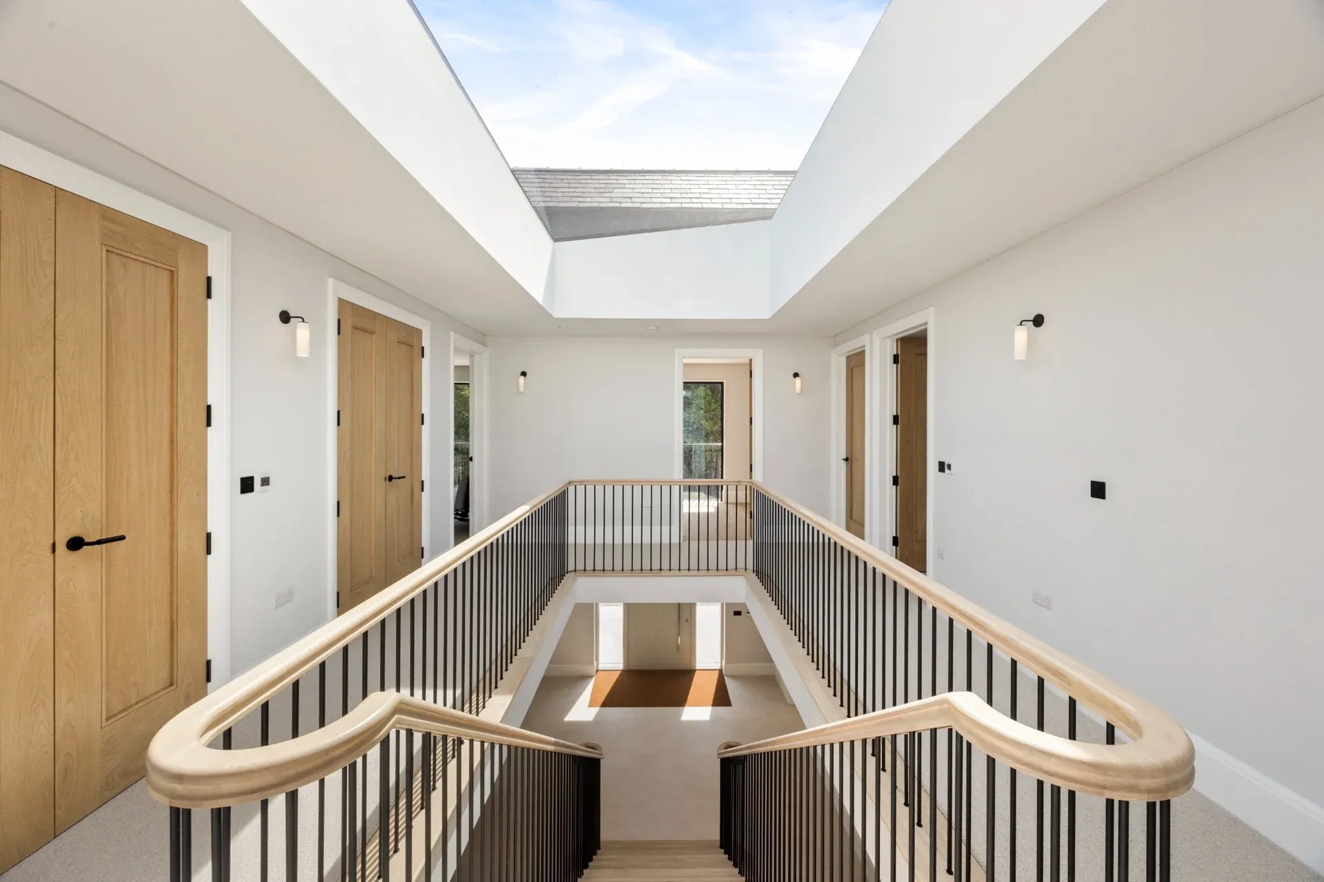 Streams Farm staircase and oak handrails beneath a large rooflight